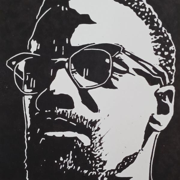 Linoprint ‘Malcolm X’ – handgedrukte A6 zwart-wit portretkaart op 250 grams papier